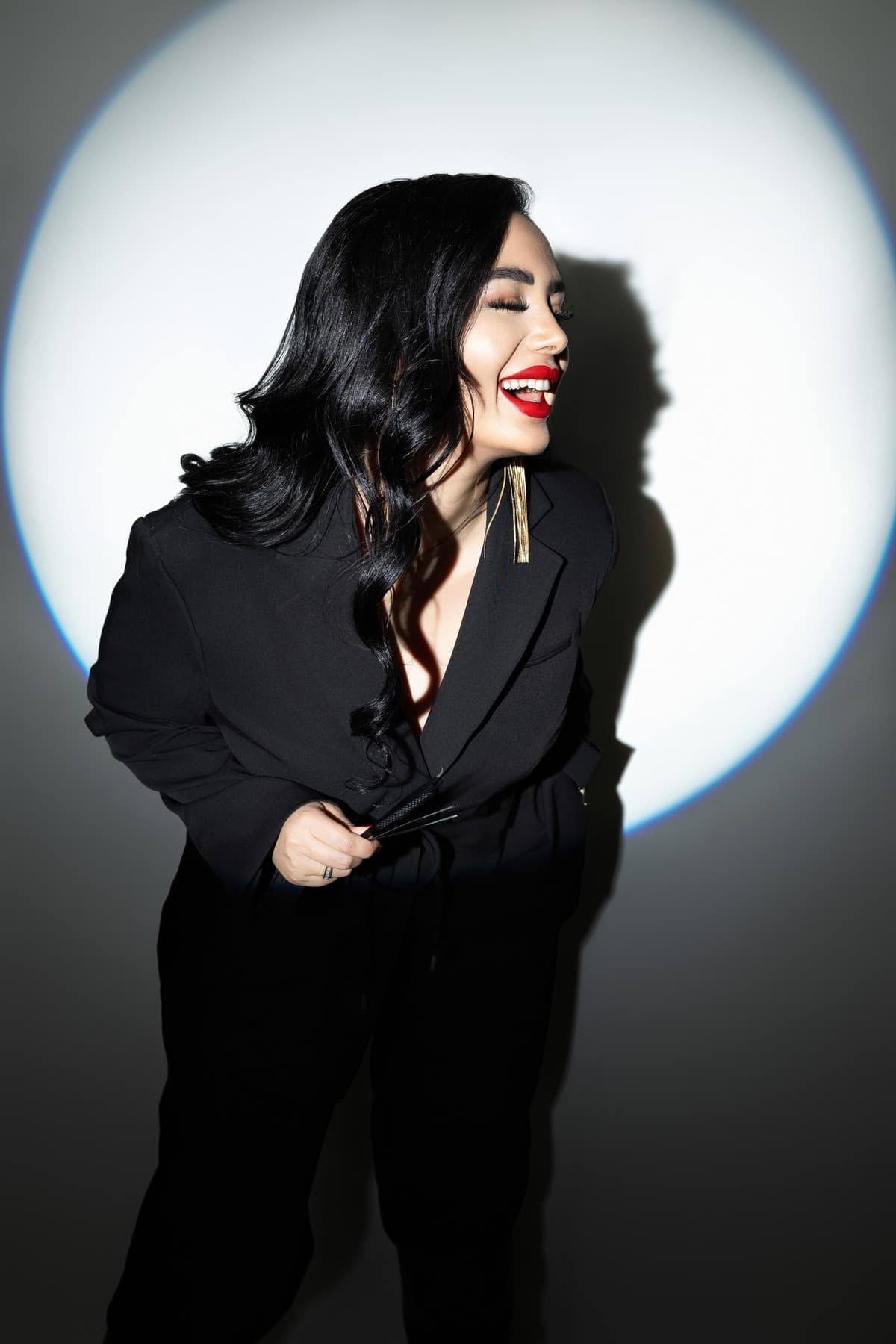 Ghada Arbi smiling in her black outfit brand portrait