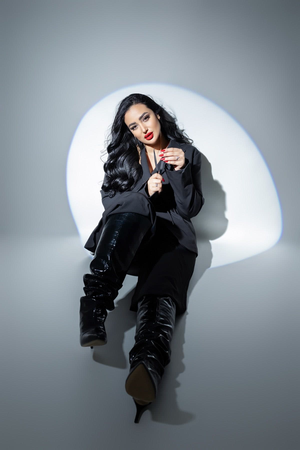 Ghada seated with her lash tools in the latest Khalifa Queen campaign